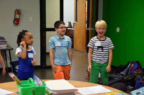 Three elementary students standing next to each other
